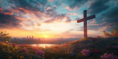 Cross silhouette at sunset overlooking city skyline and serene lake with vibrant flowers in foreground photo
