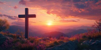 Dramatic sunset behind a wooden cross in a serene mountain landscape with blooming flowers photo