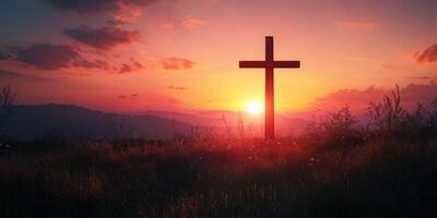 Sunset silhouette of a cross on a hilltop with vibrant clouds in the background during golden hour photo