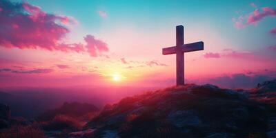 Sunset view with cross silhouette on hilltop against colorful sky and distant mountains photo