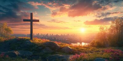 Sunset view over a city skyline with a cross and blooming flowers in the foreground photo