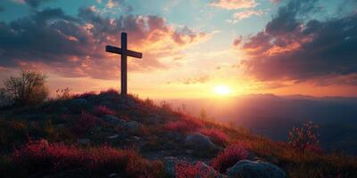 Sunset view from a hilltop with a wooden cross silhouetted against colorful clouds photo