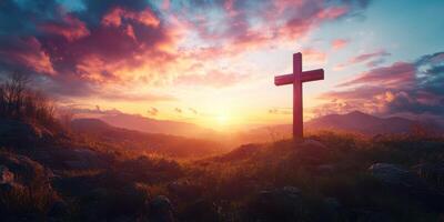 Sunset over mountains with a wooden cross on a hillside overlooking a peaceful valley photo