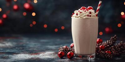 Festive milkshake with whipped cream and berries on a dark background surrounded by holiday decorations photo