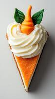 Delicious slice of orange carrot cake topped with whipped cream and decorative leaves photo
