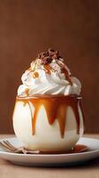 Creamy dessert delight topped with whipped cream and caramel sauce served in an elegant bowl photo