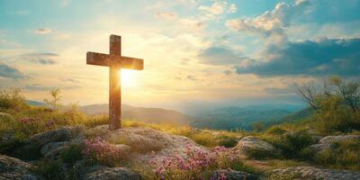 Beautiful sunset over a cross with flowers in a serene landscape near mountains photo