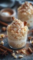 Creamy rice pudding dessert with whipped cream and cinnamon served in glass cup photo