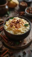 Delicious rice pudding served in a rustic bowl with spices and fresh mint leaves on a wooden table photo