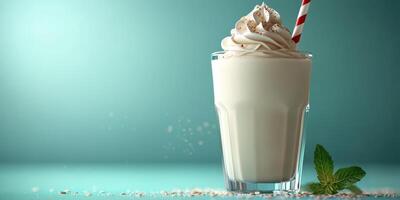 Creamy milkshake topped with whipped cream and a striped straw on a vibrant background photo