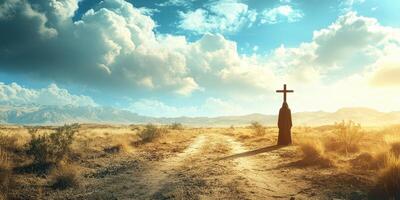 Silhouette of a figure holding a cross in a vast desert landscape during golden hour photo