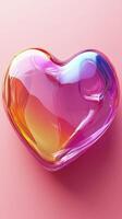Colorful heart-shaped glass object resting on a smooth pink background with a vibrant gradient effect photo