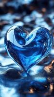Blue heart-shaped sculpture rests on a reflective surface adorned with shimmering textures and hints of light photo