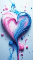 Colorful heart shape created with flowing paint in vivid pink and blue hues on a smooth surface photo