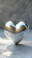 Shiny metallic heart reflects soft light in a serene and minimalist setting photo