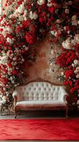 Elegant vintage sofa surrounded by vibrant red and white floral arrangements in a romantic setting photo