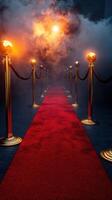 Red carpet entrance with velvet ropes and glowing lights at a glamorous event photo