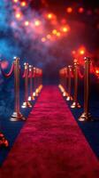 Luxurious red carpet pathway with golden stanchions under colorful lights at an evening event photo