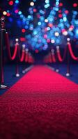 Elegant red carpet pathway adorned with vibrant lights at a glamorous event in the evening photo