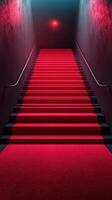 Elegant red carpet leading up a dimly lit staircase in an upscale venue at night photo