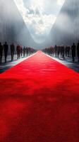 Crowds of people walking on a red carpet in a dramatic setting under a cloudy sky photo