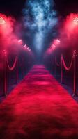 Red carpet lined with lights and smoke creates a dramatic entrance for an event at night photo