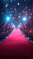 Brightly lit red carpet path leading to a glamorous event during nighttime with glowing bokeh effects and elegant barriers photo