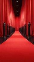 Elegant red carpet entrance with velvet curtains and black stanchions leading to a glamorous event venue photo