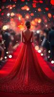 Elegant woman in a sparkling red gown stands on the red carpet at a glamorous evening event, surrounded by bright lights and crowds photo