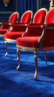 Elegant red chairs arranged on a vibrant blue carpet in an opulent interior setting with rich colors and textures photo