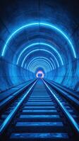 Illuminated tunnel with blue neon lights and railway tracks stretching into the distance photo