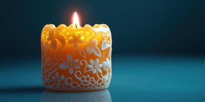 Intricately carved candle glowing softly in a dark blue setting photo