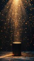 Golden particles burst from a cylindrical container, illuminating the dark background with a sparkling glow photo