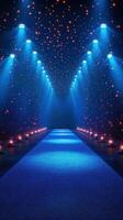 Bright blue runway illuminated by stage lights with shimmering stars in a darkened venue at night photo