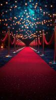 Red carpet leading to an illuminated path with twinkling lights at a formal event in the evening photo
