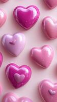 Colorful heart-shaped decorations in various shades of pink arranged on a pastel background for festive occasions photo
