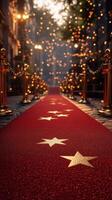Elegant red carpet path lined with golden stanchions and twinkling lights at an evening event in a festive street photo