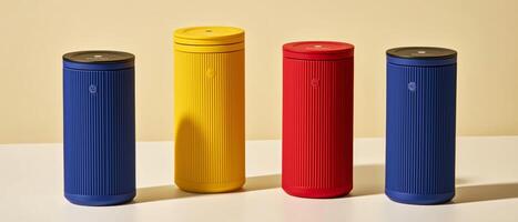 Colorful Wireless Speakers On Beige Surface photo
