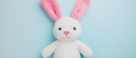 White Plush Bunny Toy On Blue photo