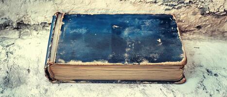 Old Blue Book on Textured Surface photo