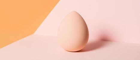 Peach Beauty Blender On Pink Surface photo