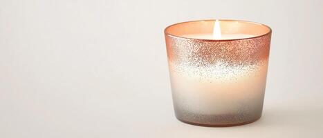 Burning Candle With Rose Gold Holder photo