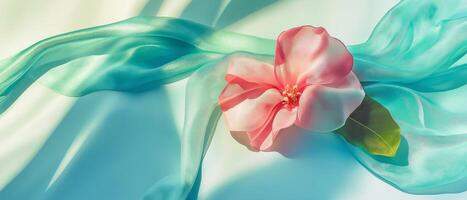 Pink Flower And Blue Flowing Fabric photo