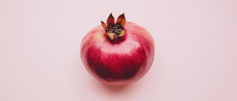 Fresh Pomegranate Fruit On Pink Surface photo