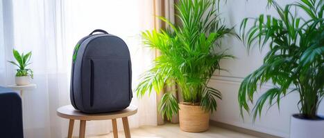 Dark Backpack on Stool in Room photo