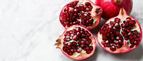Fresh Pomegranates on Marble Surface, Top View photo