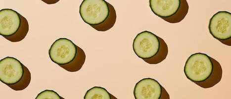 Cucumber Slices On Beige Background Pattern photo