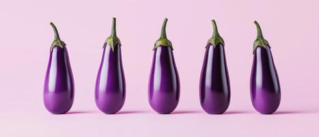 Five Eggplants Against Pale Pink Background photo