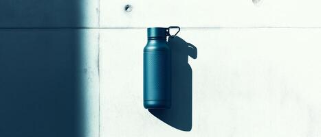 Blue Water Bottle Against Concrete Wall photo