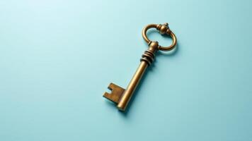 Antique Brass Key On Blue Background photo